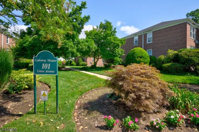 a view of a park with a house in the background