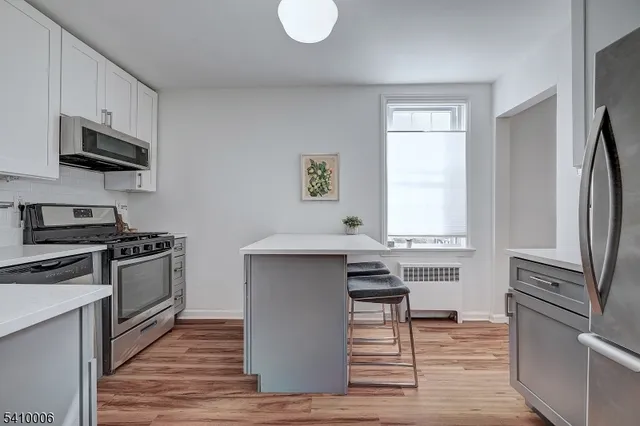a kitchen with stainless steel appliances a stove a sink and a refrigerator