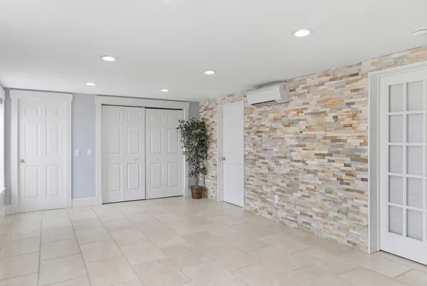 a view of a house with a yard and a large tree
