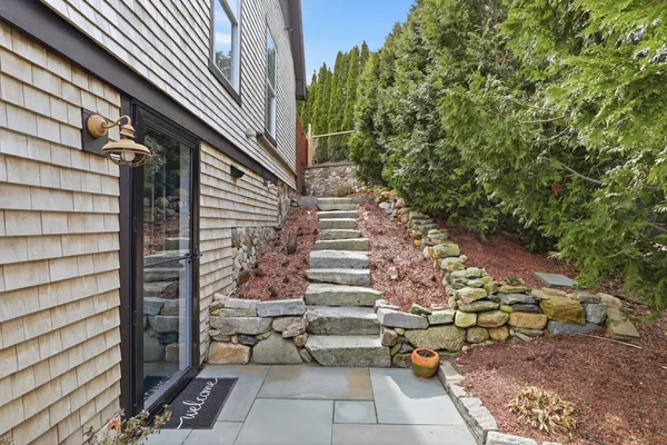a view of a house with backyard and sitting area