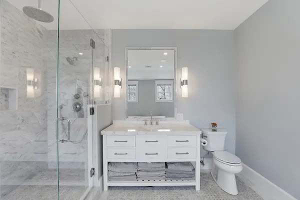 a bathroom with a sink toilet and shower