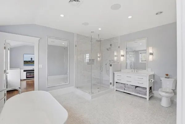 a bathroom with a double vanity sink toilet and shower