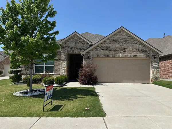 a front view of a house with a yard and outdoor seating