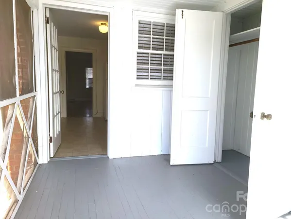 a view of a room with a white door