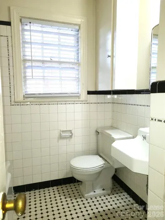 a bathroom with a toilet a sink and a shower