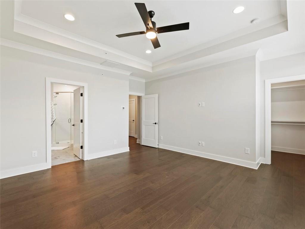 355 Chiswick Circle Alpharetta, GA 30009 - Photo 25 of 57 an empty room with wooden floor ceiling fan and windows