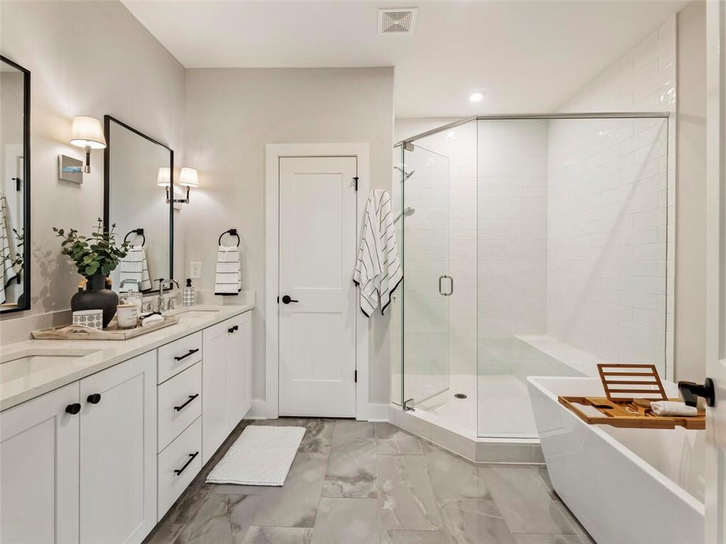 355 Chiswick Circle Alpharetta, GA 30009 - Photo 26 of 57 a spacious bathroom with a granite countertop sink a mirror and a bathtub