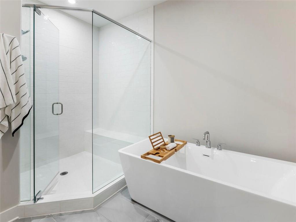 355 Chiswick Circle Alpharetta, GA 30009 - Photo 27 of 57 a bathroom with a tub and a shower