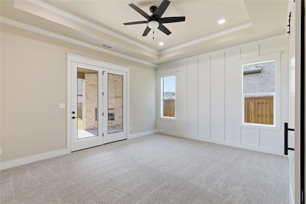 709 Anne Road Van Alstyne, TX 75495 - Photo 17 of 28 Room with tray ceiling featuring a ceiling fan and recessed lighting