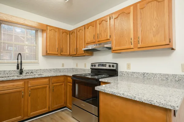 a kitchen with refrigerator and cabinets