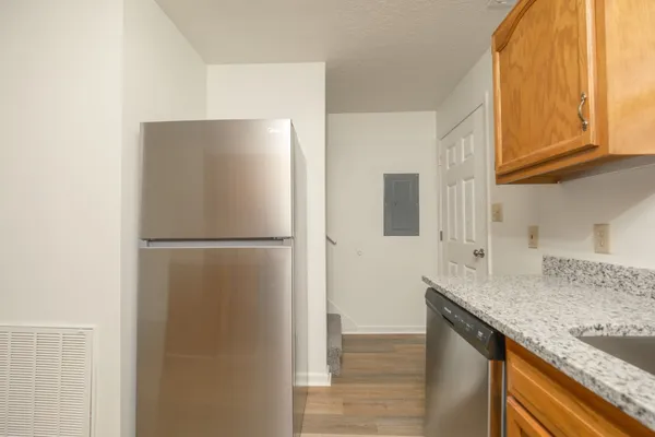 a kitchen with stainless steel appliances granite countertop a refrigerator sink and cabinets