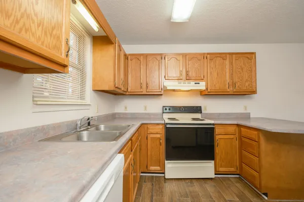 a kitchen with stainless steel appliances granite countertop a sink stove and cabinets