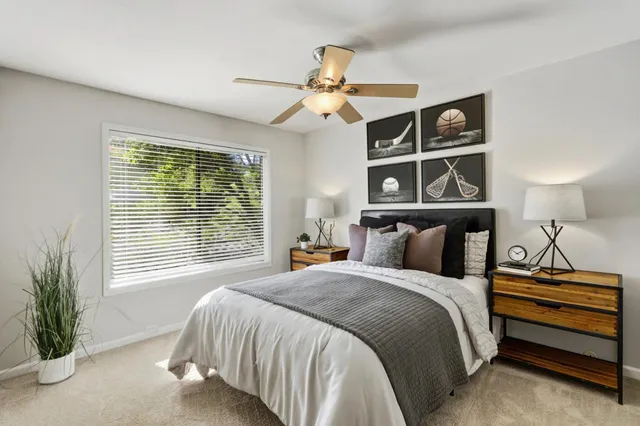 a bedroom with a bed and a chandelier