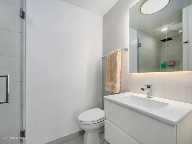 a bathroom with a sink toilet and a mirror