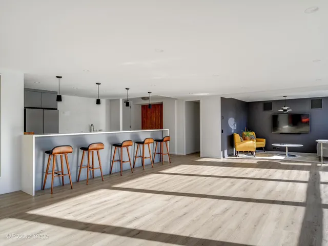 a view of kitchen with furniture and living room