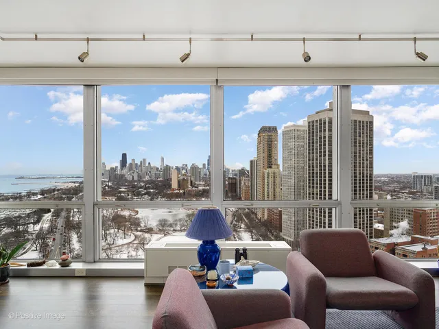 a living room with furniture and a floor to ceiling window