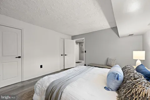 a bedroom with a bed and a night stand