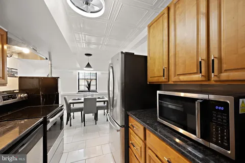 a kitchen with stainless steel appliances a stove microwave and refrigerator