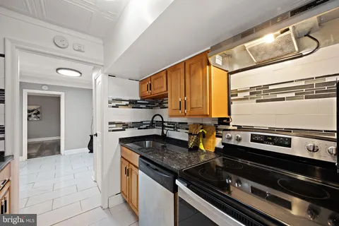 a kitchen with a stove and a sink