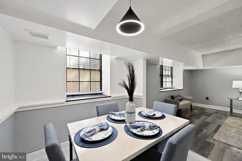 a view of a dining room with furniture window and wooden floor