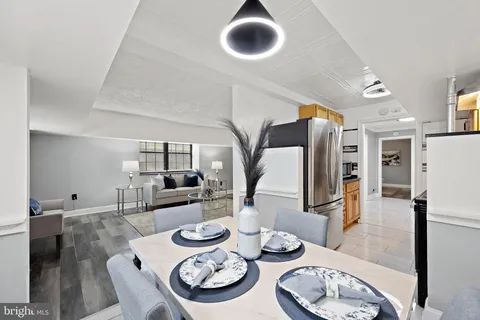 a dining room with furniture and wooden floor