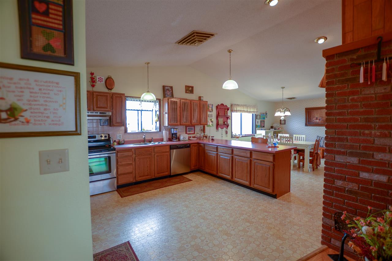 1181 19 Road Fruita, CO 81521 - Photo 6 of 26 a kitchen with stainless steel appliances wooden cabinets a center island and a refrigerator