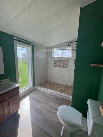 a bathroom with a toilet and a shower