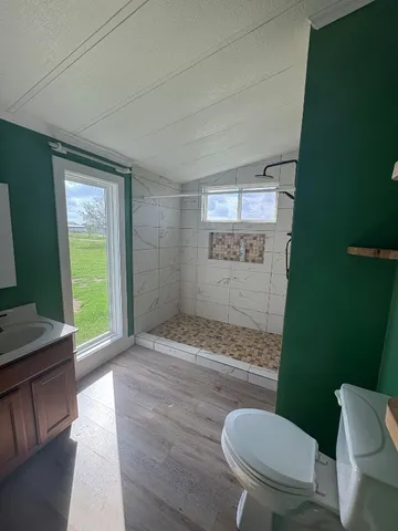 a bathroom with a toilet and a shower
