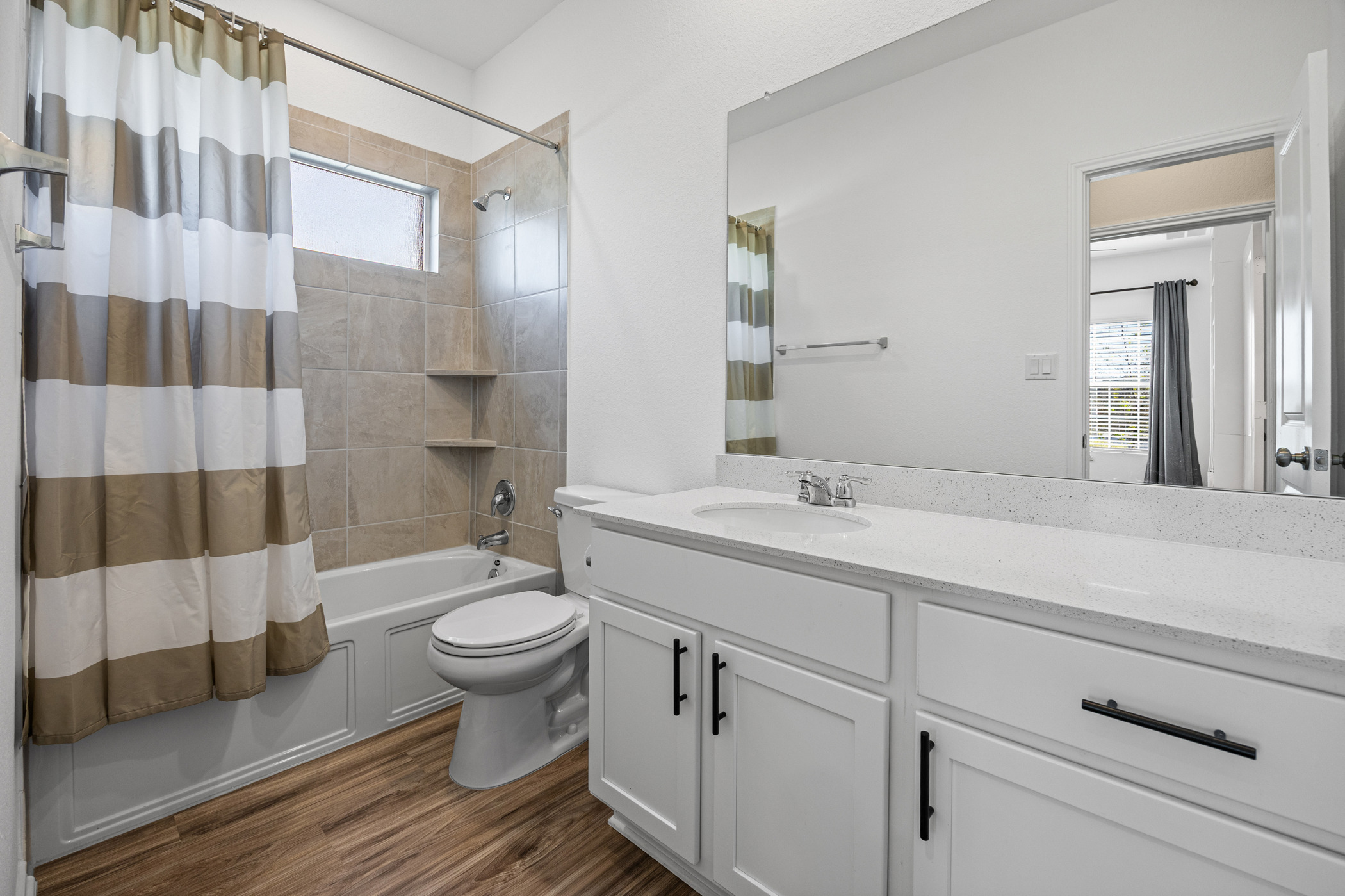 1609 Woolsey Way Leander, TX 78641 - Photo 12 of 29 Full bath with vanity, shower / bath combo, and dark wood finished floors