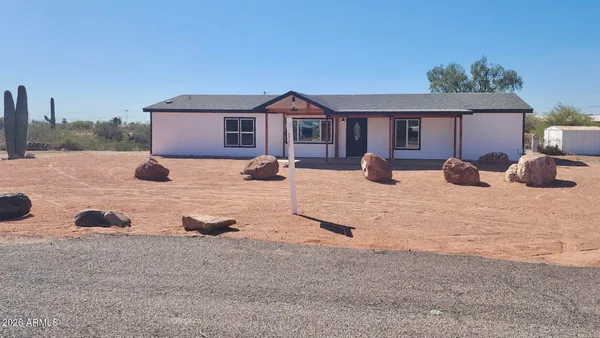 a large kitchen with stainless steel appliances granite countertop a stove a sink dishwasher and a microwave with wooden floor