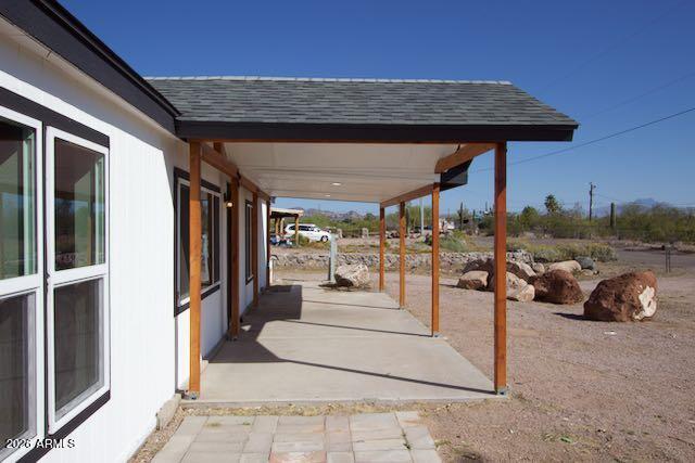 1470 South Bowman Road Apache Junction, AZ 85119 - Photo 17 of 57 a view of a couches and table in the patio
