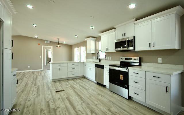 1470 South Bowman Road Apache Junction, AZ 85119 - Photo 2 of 57 a large kitchen with stainless steel appliances granite countertop a stove a sink dishwasher and a microwave with wooden floor