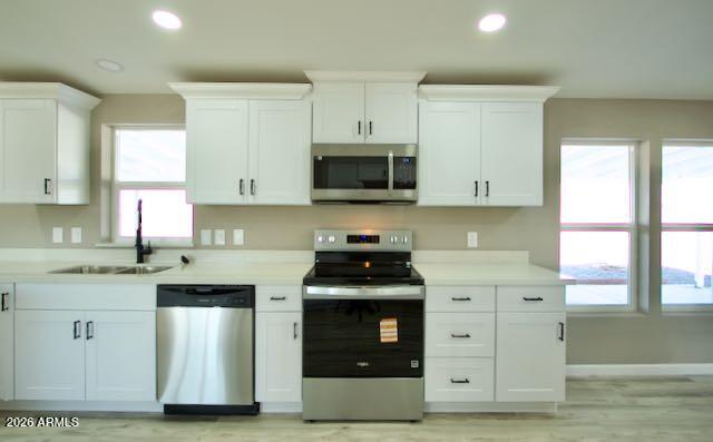 1470 South Bowman Road Apache Junction, AZ 85119 - Photo 22 of 57 a kitchen with stainless steel appliances granite countertop white cabinets and a stove top oven