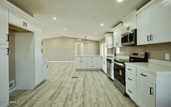 an empty room with closet and a chandelier fan