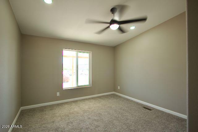 1470 South Bowman Road Apache Junction, AZ 85119 - Photo 27 of 57 an empty room with a window and a fan