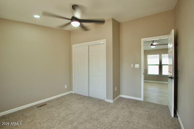 1470 South Bowman Road Apache Junction, AZ 85119 - Photo 28 of 57 an empty room with closet and a chandelier fan