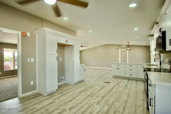 a large kitchen with stainless steel appliances granite countertop a stove a sink and a refrigerator
