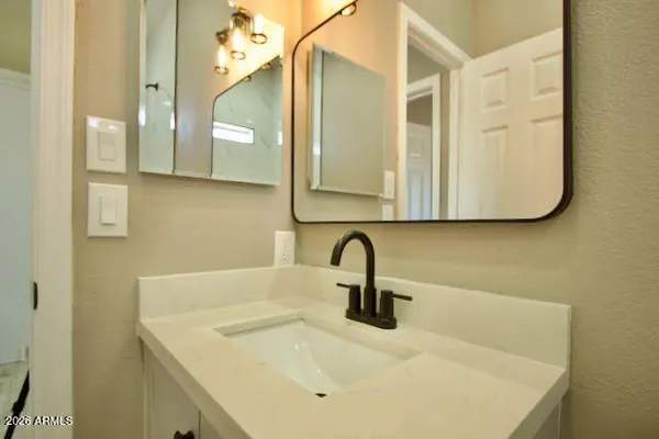 a white toilet sitting next to a bathroom sink and vanity