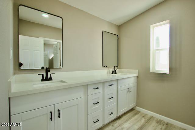 1470 South Bowman Road Apache Junction, AZ 85119 - Photo 34 of 57 a bathroom with a double vanity sink and a mirror
