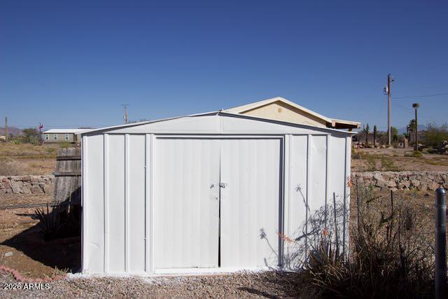 1470 South Bowman Road Apache Junction, AZ 85119 - Photo 43 of 57 a front view of a house with a yard