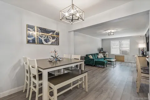 a view of a dining room with furniture wooden floor and a chandelier