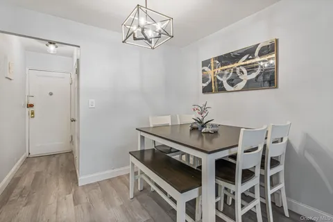 a view of a dining room with furniture wooden floor and chandelier