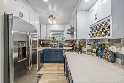 a kitchen with stainless steel appliances and a refrigerator