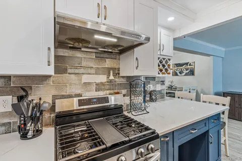 a kitchen with a stove and cabinets