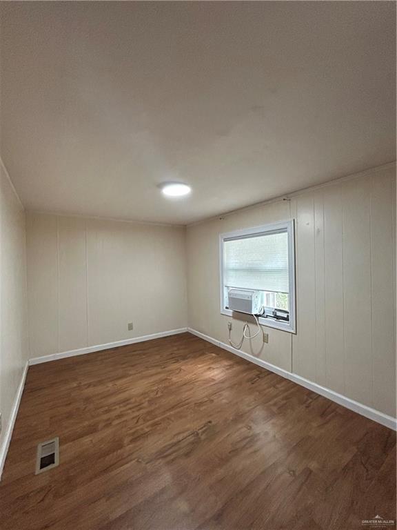 1205 Maple Street Harlingen, TX 78552 - Photo 18 of 23 an empty room with wooden floor and windows