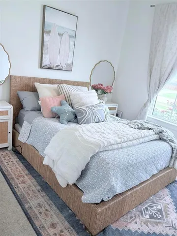 a dining room with furniture and large windows