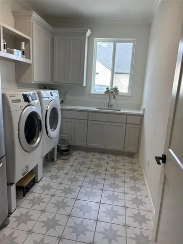 a room with a washing machine and sink