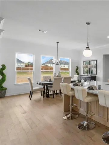 a kitchen with a counter space a sink and living room view