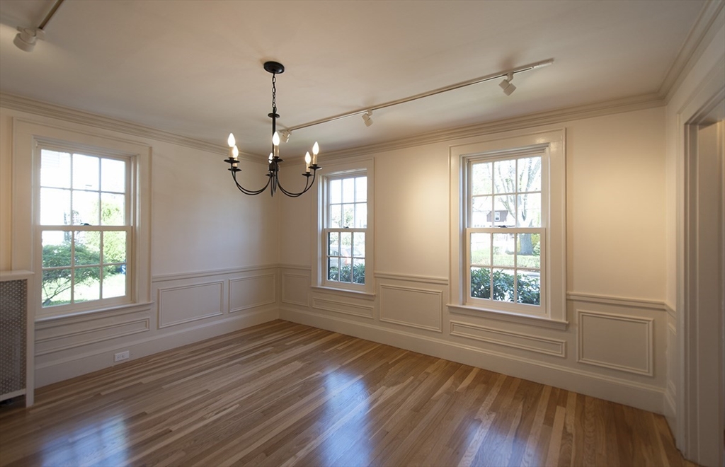 153 Watson Road Belmont, MA 02478 - Photo 4 of 20 a view of an empty room with wooden floor and a window