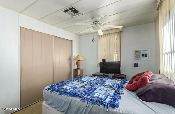 a bedroom with a bed and a window